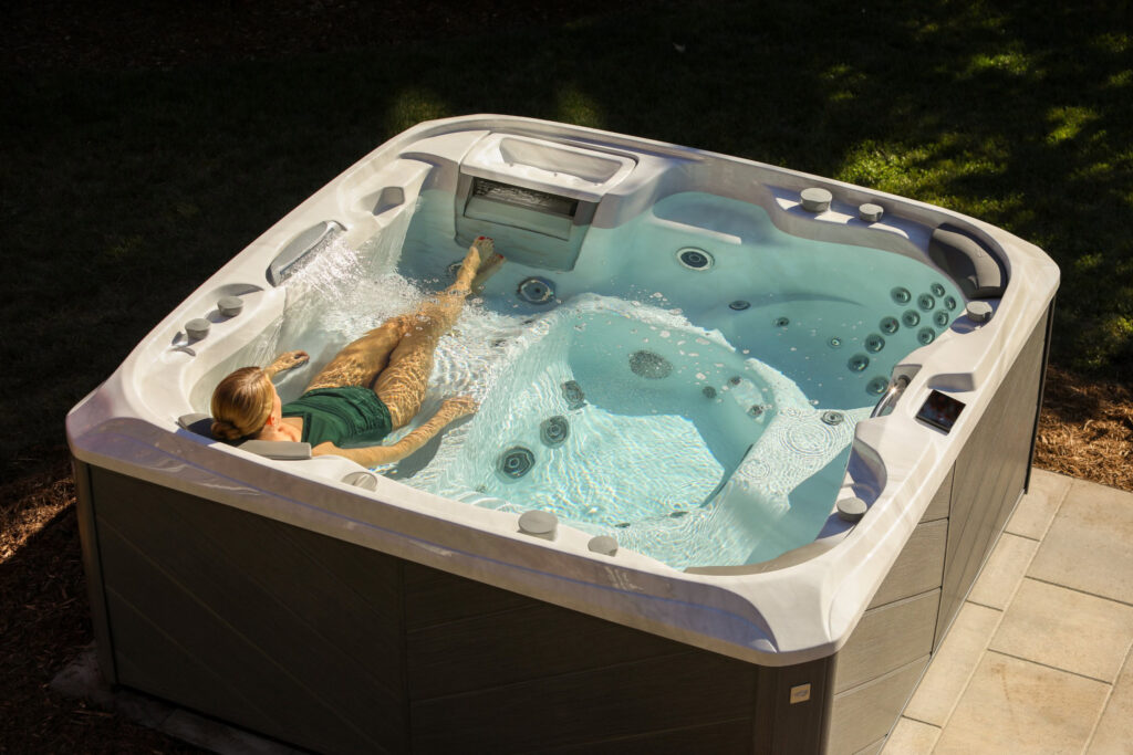 woman relaxing in sundance spas 880 series hot tub 19